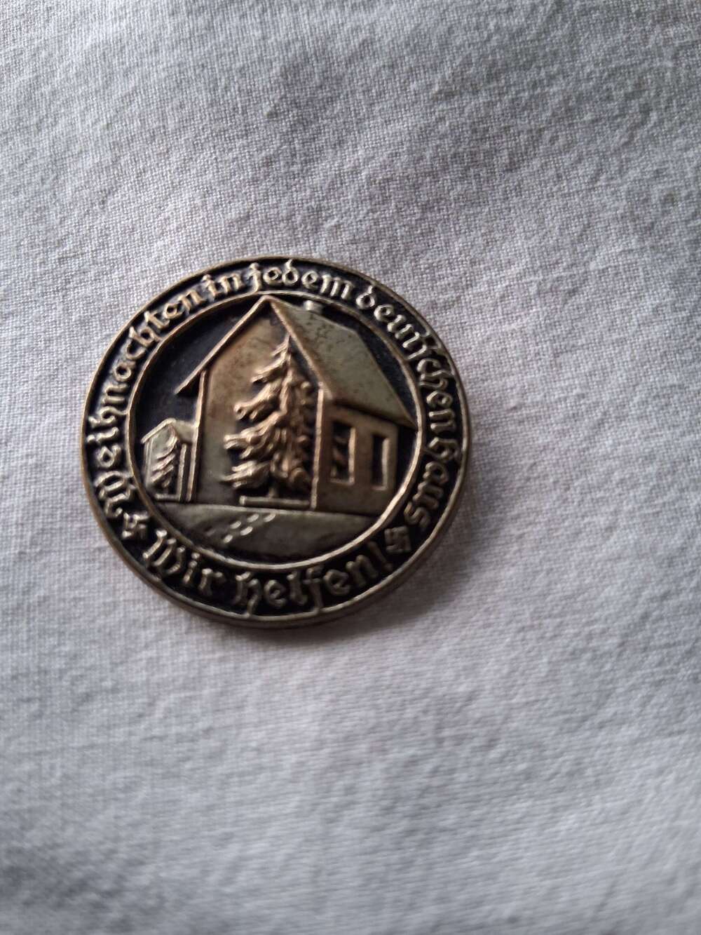Third Reich day badge priced due to condition
