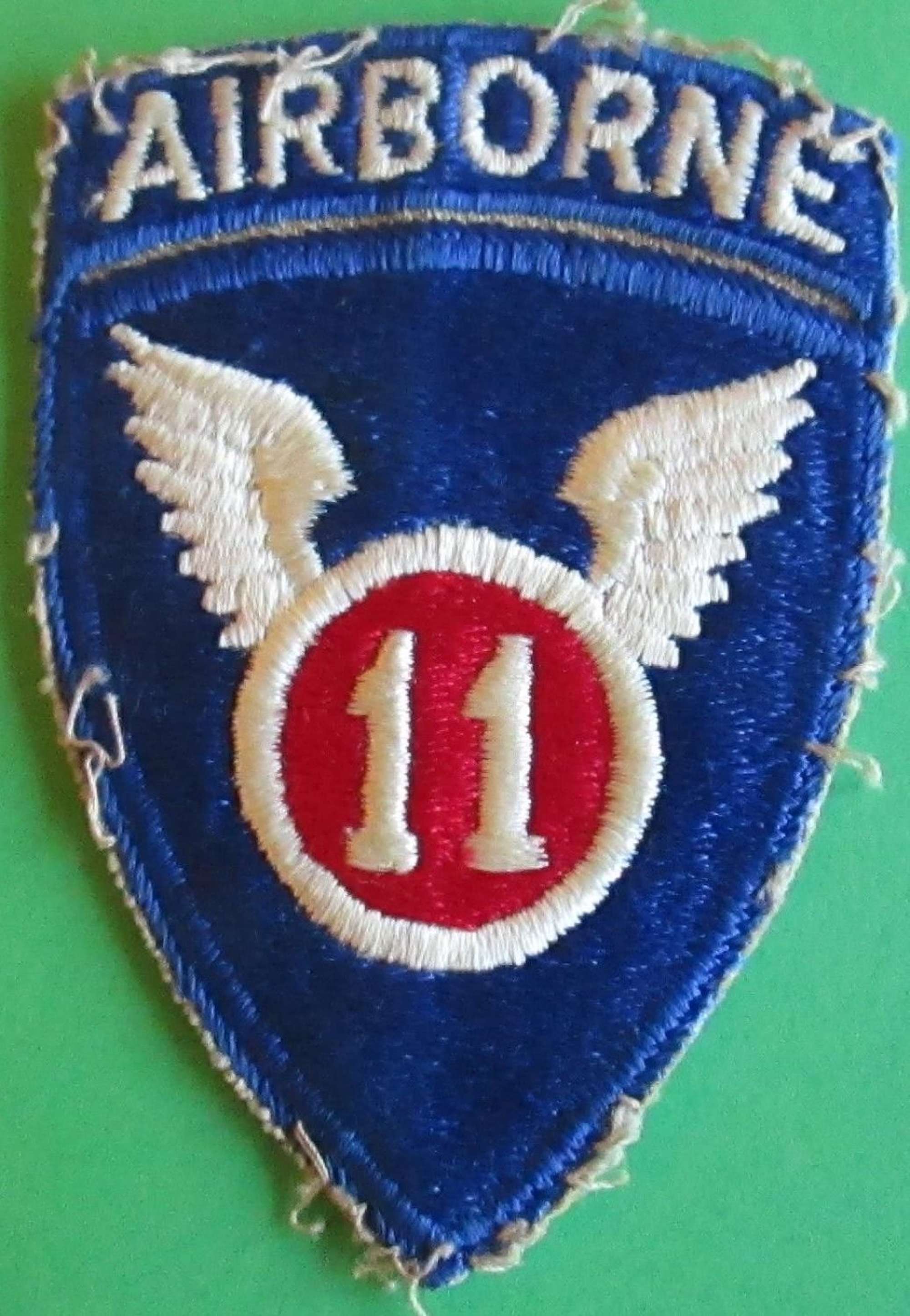 A GOOD WWII US 11th AIRBORNE FORCES ARM BADGE