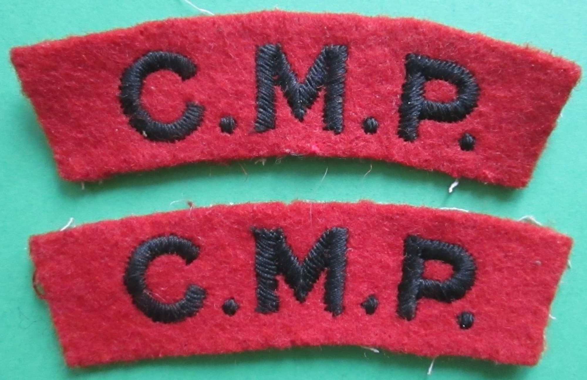 A MATCHING USED PAIR OF CORPS OF MILITARY POLICE SHOULDER TITLES