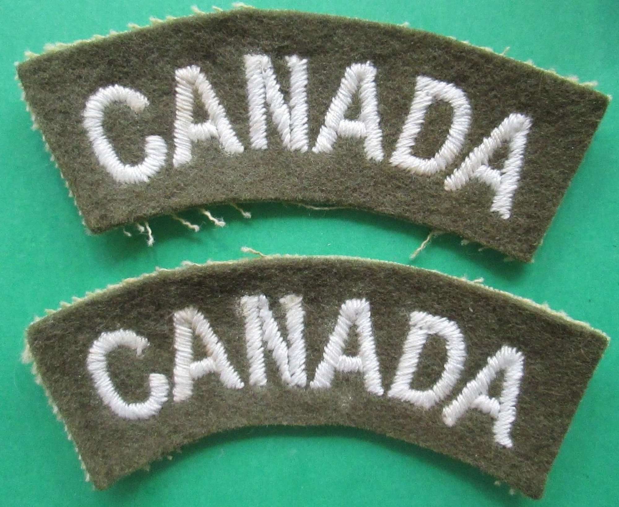 A PAIR OF THE CANADIAN WWII CANADA SHOULDER TITLES CURVED