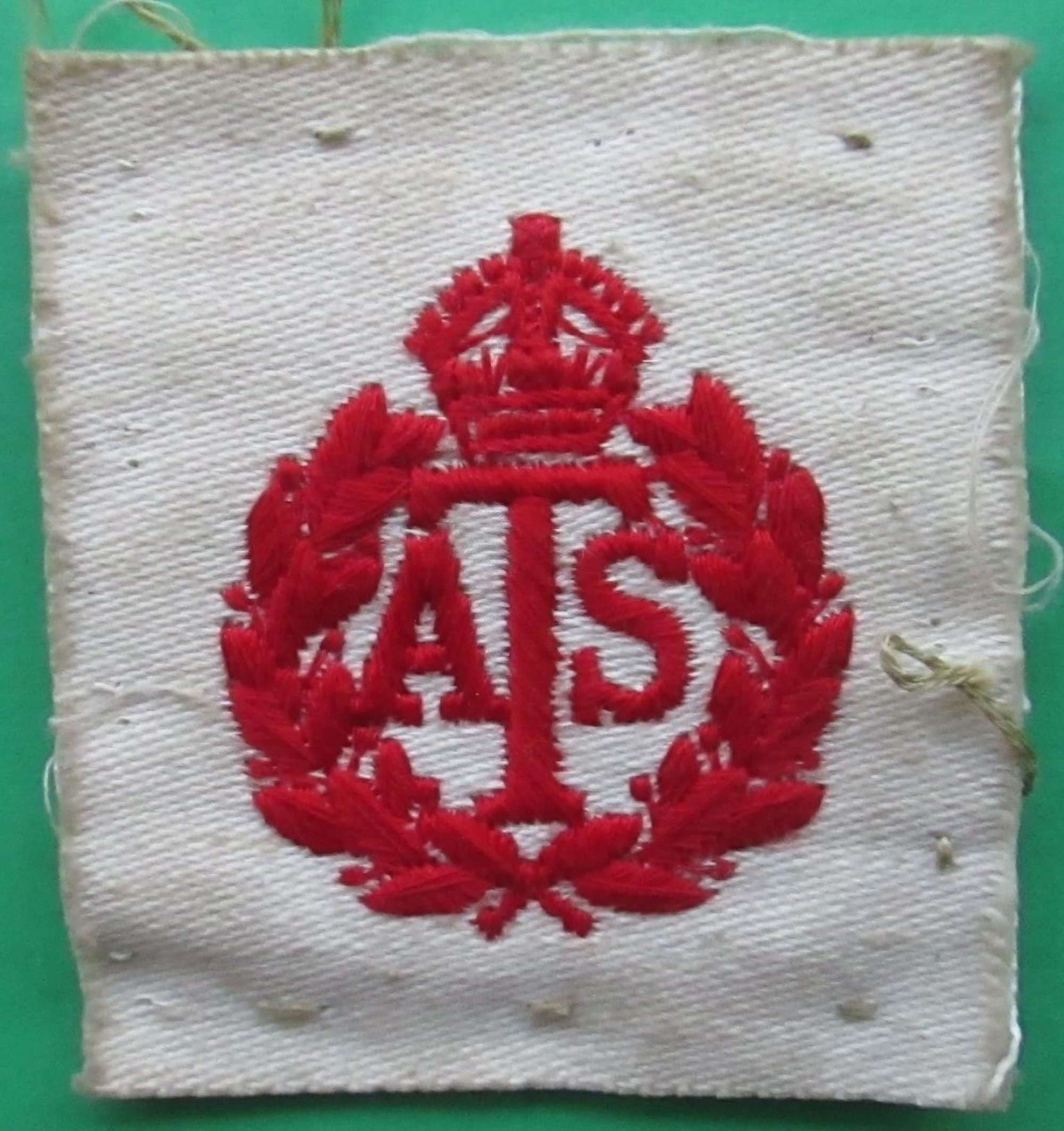 A SCARCE WWII ATS RED ON WHITE BREAST / CAP BADGE