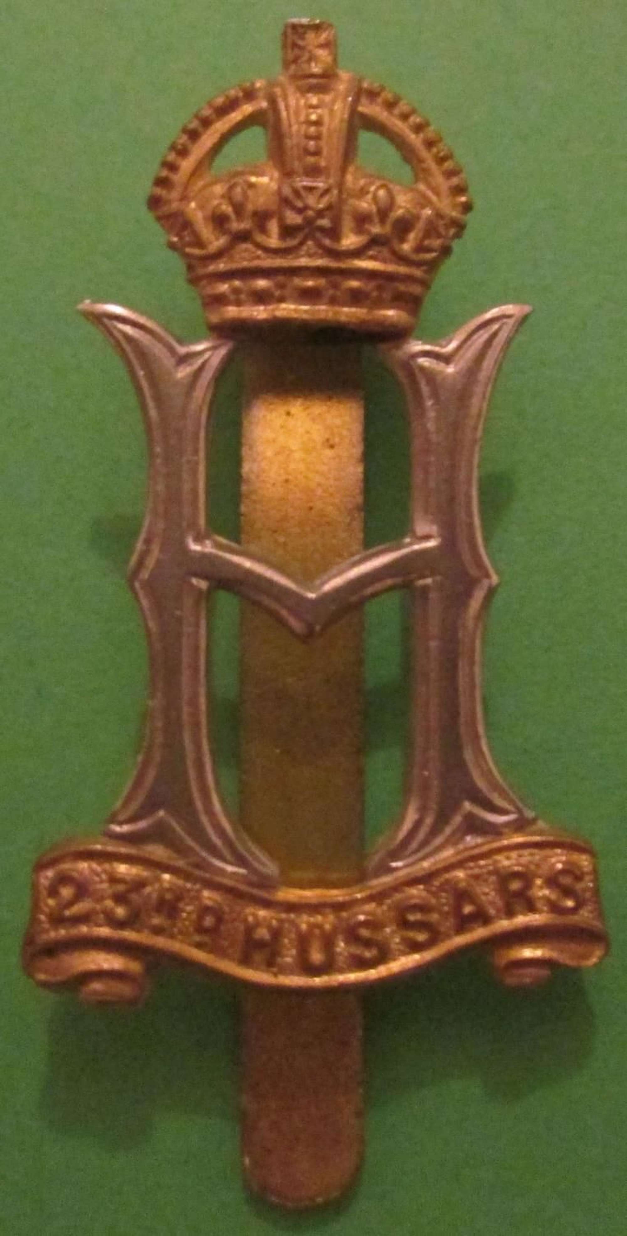 A WWII 23RD HUSSARS CAP BADGE