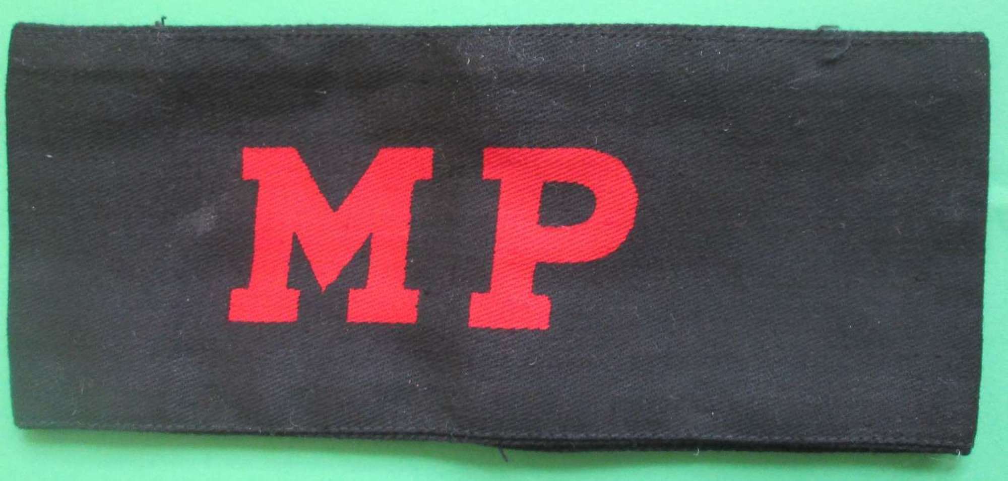 A WWII PRINTED MILITARY POLICE ARMBAND PRINTED