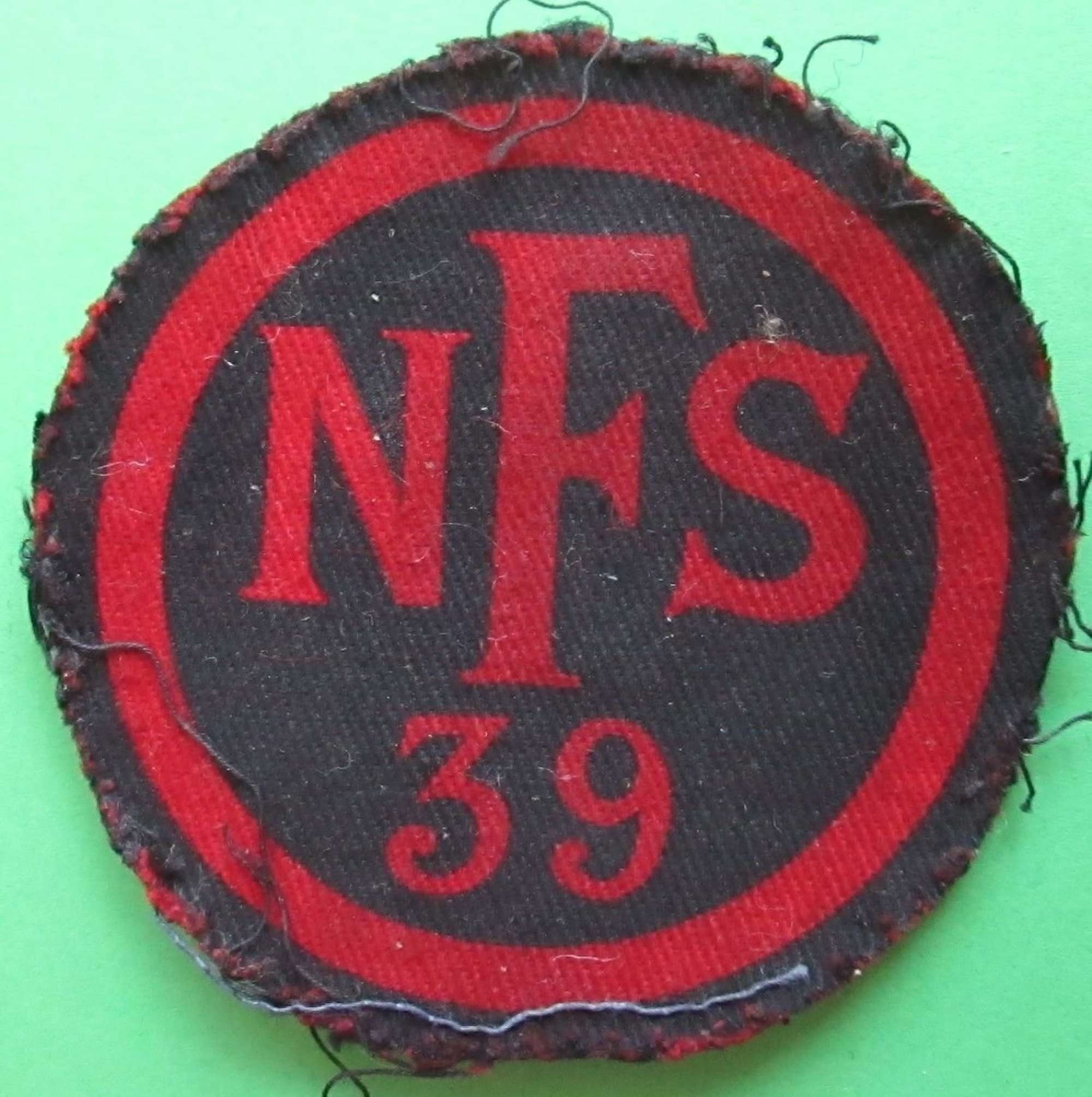 A WWII PRINTED NATIONAL FIRE SERVICE AREA 39 BREAST BADGE