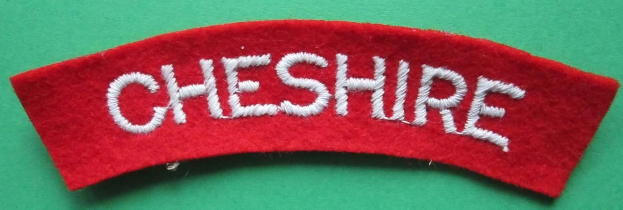 LATE WWII CHESHIRE REGT SHOULDER TITLE