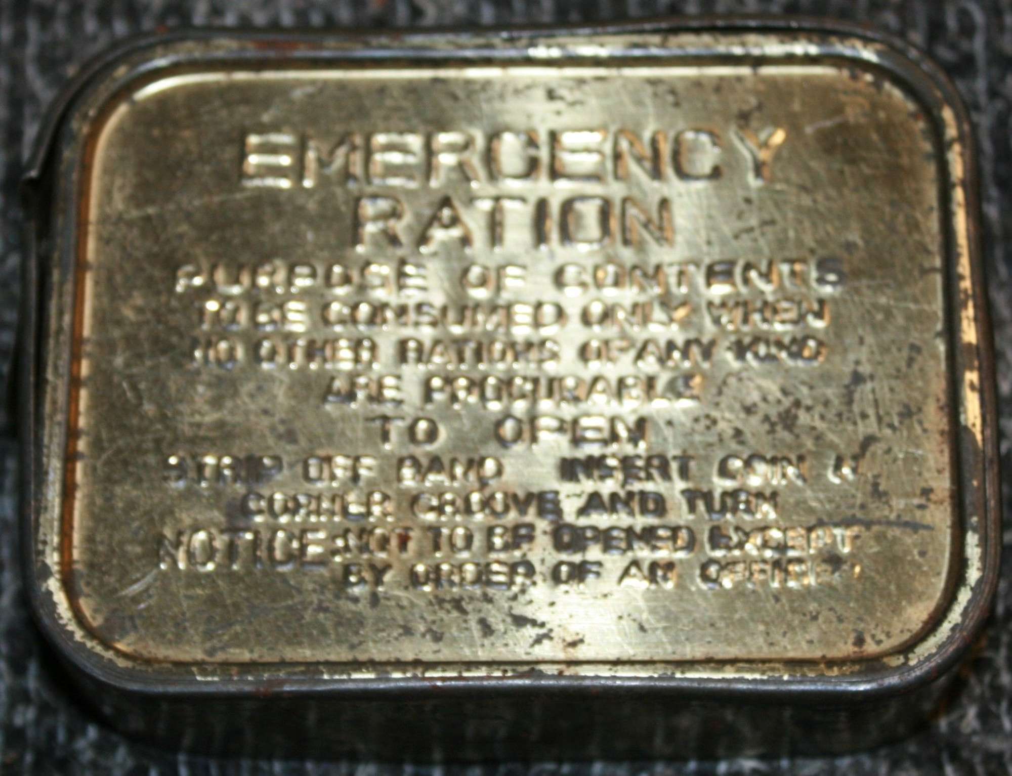 A WWII EMERGENCY RATION TIN WITH THE OUTER BAND