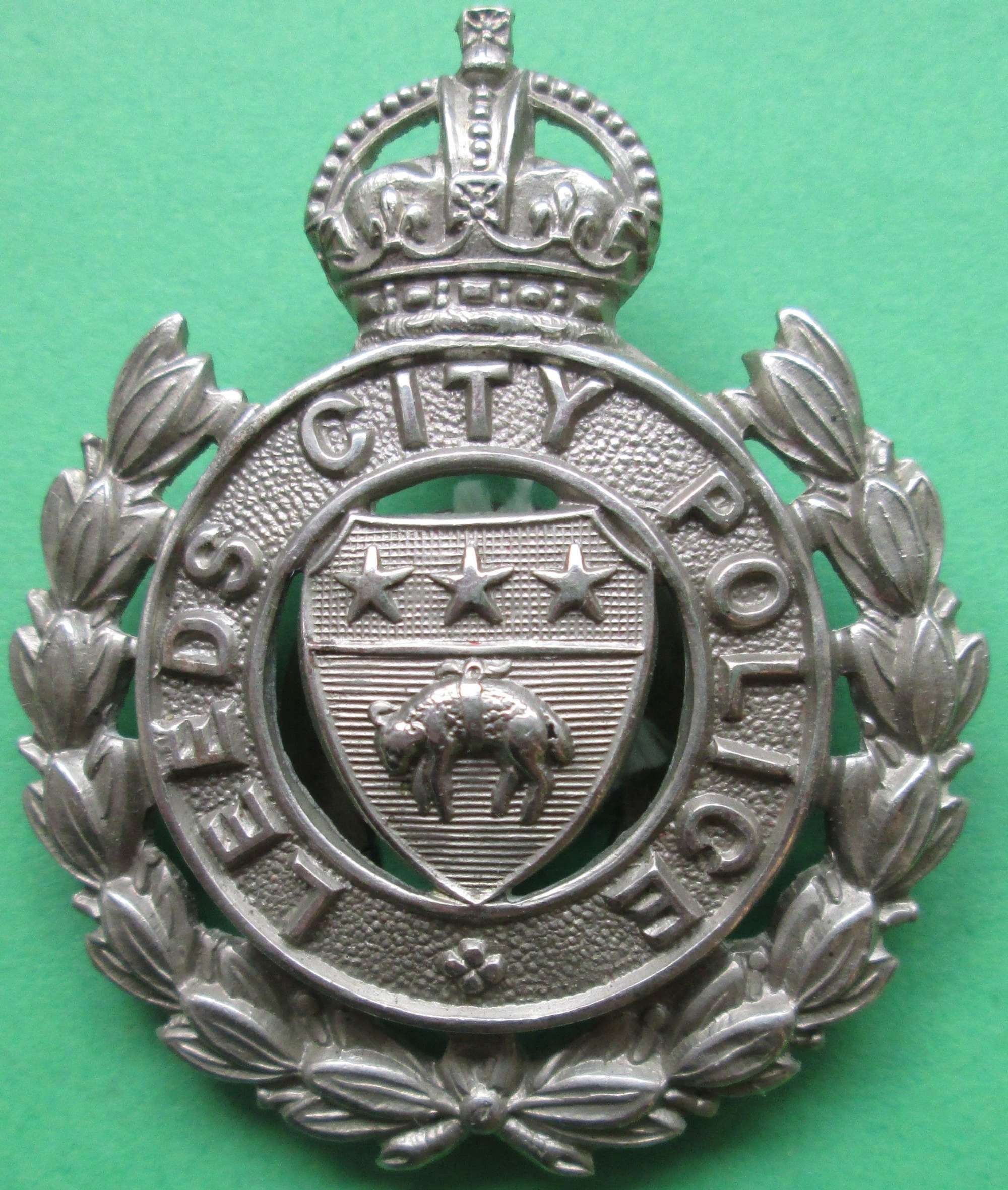 A LEEDS CITY POLICE LAPEL BADGE NUMBERED 24 TO THE FIXING