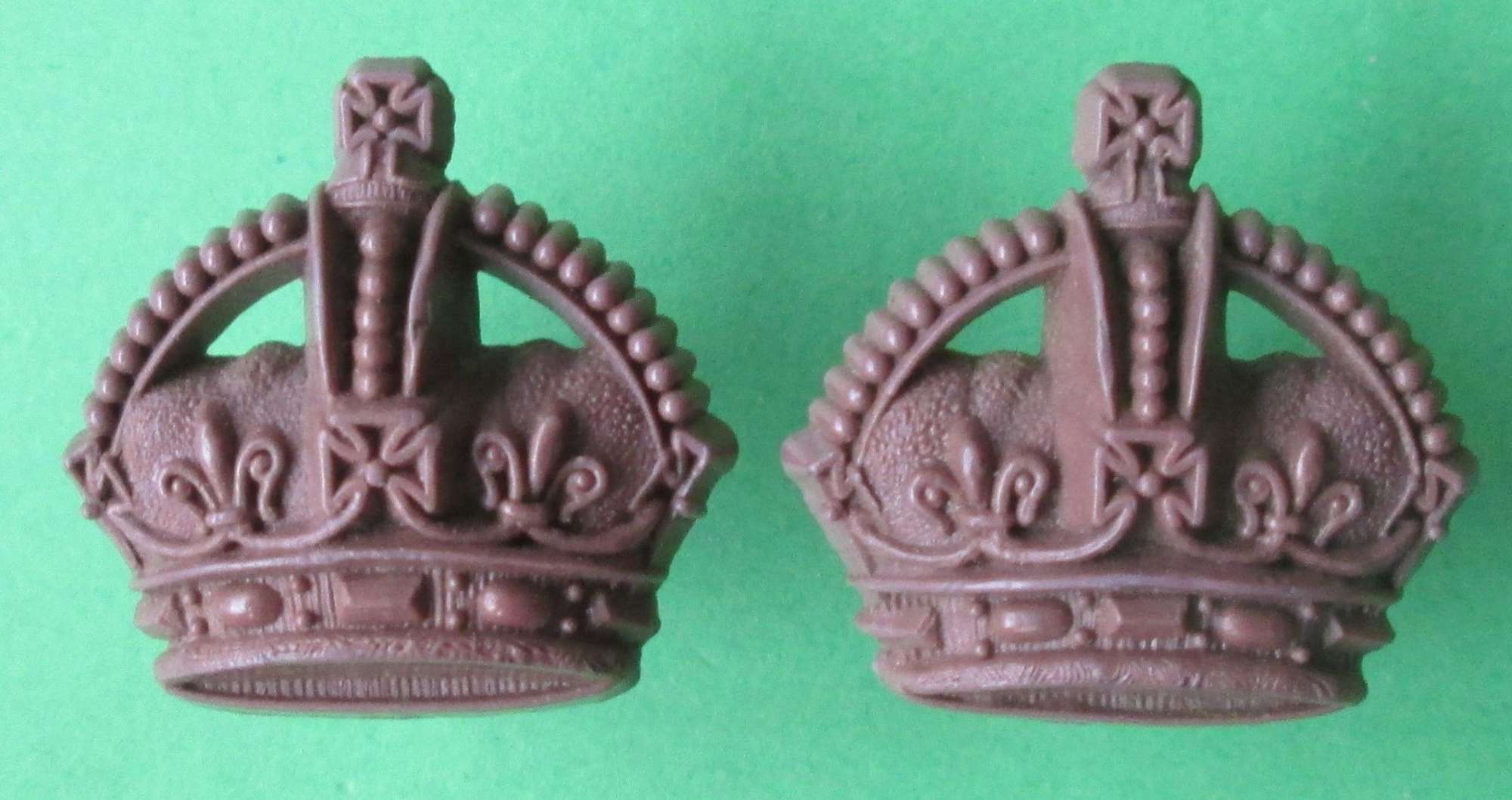 A WWII PAIR OF PLASTIC OFFICERS KINGS CROWNS