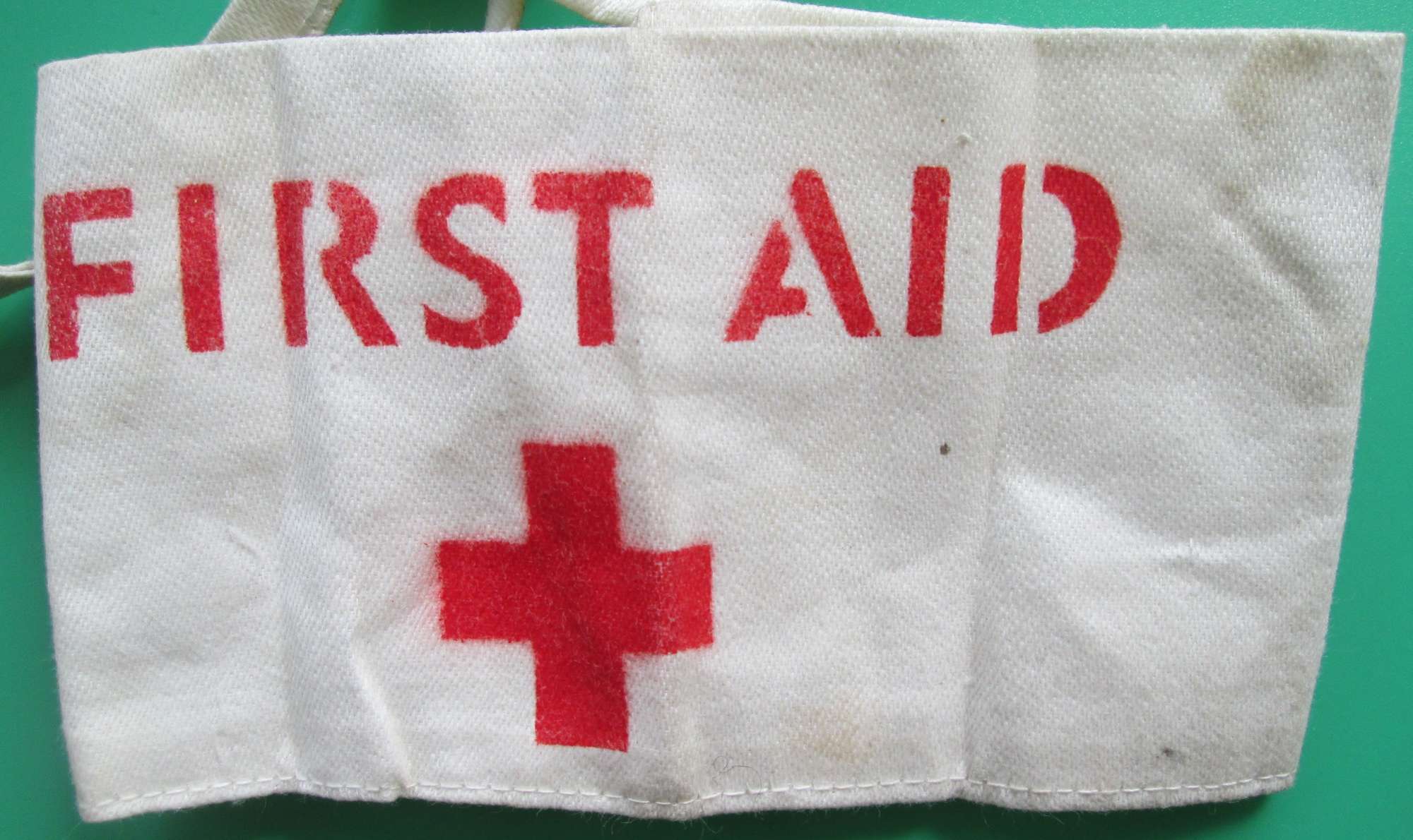 A FIRST AID WARDENS TIE ON ARM BAND