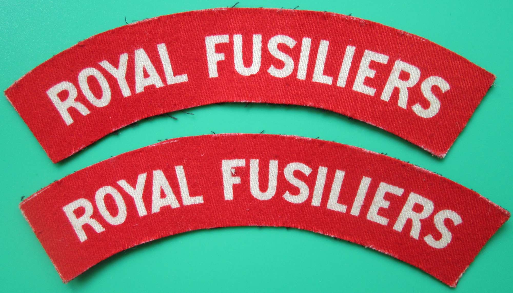 A PAIR OF ROYAL FUSILIERS SHOULDER TITLES