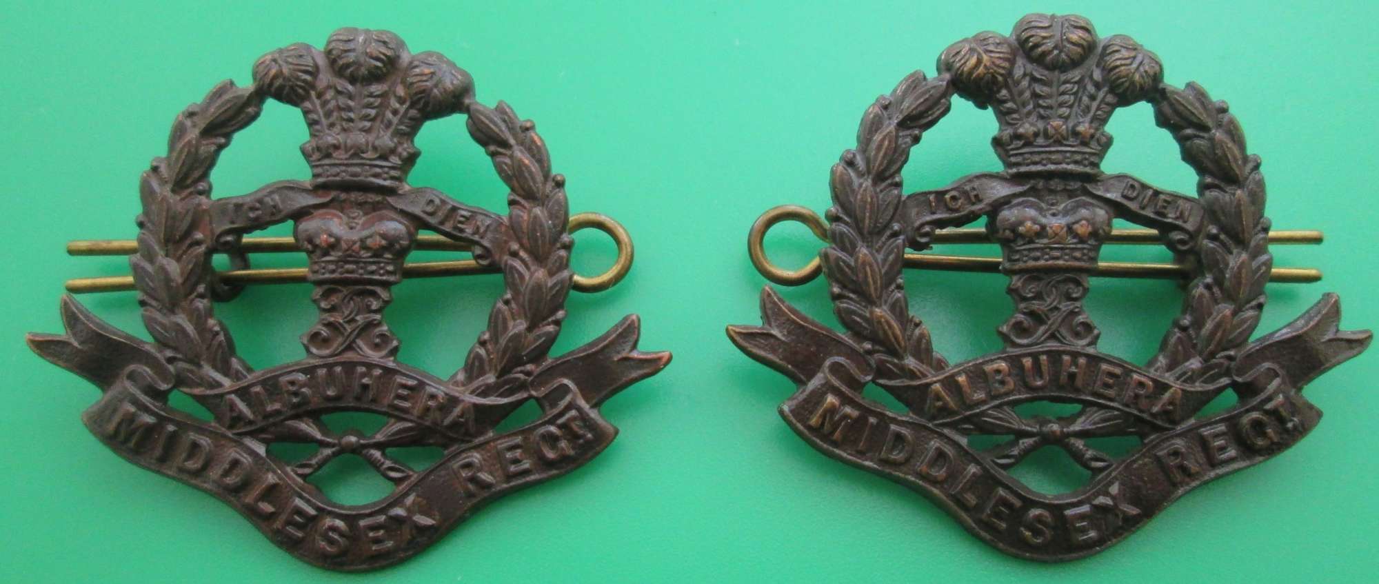 A PAIR OF OFFICERS BRONZE COLLAR DOGS FOR THE MIDDLESEX REGIMENT