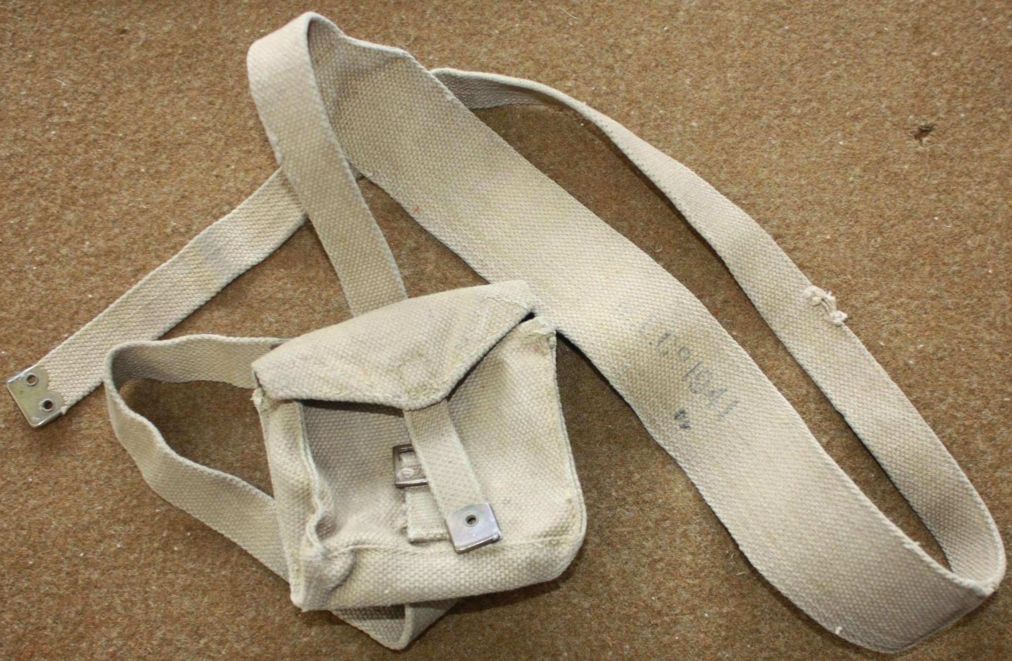 A WWII BRITISH 1941 DATED FLARE TIN POUCH STRAP