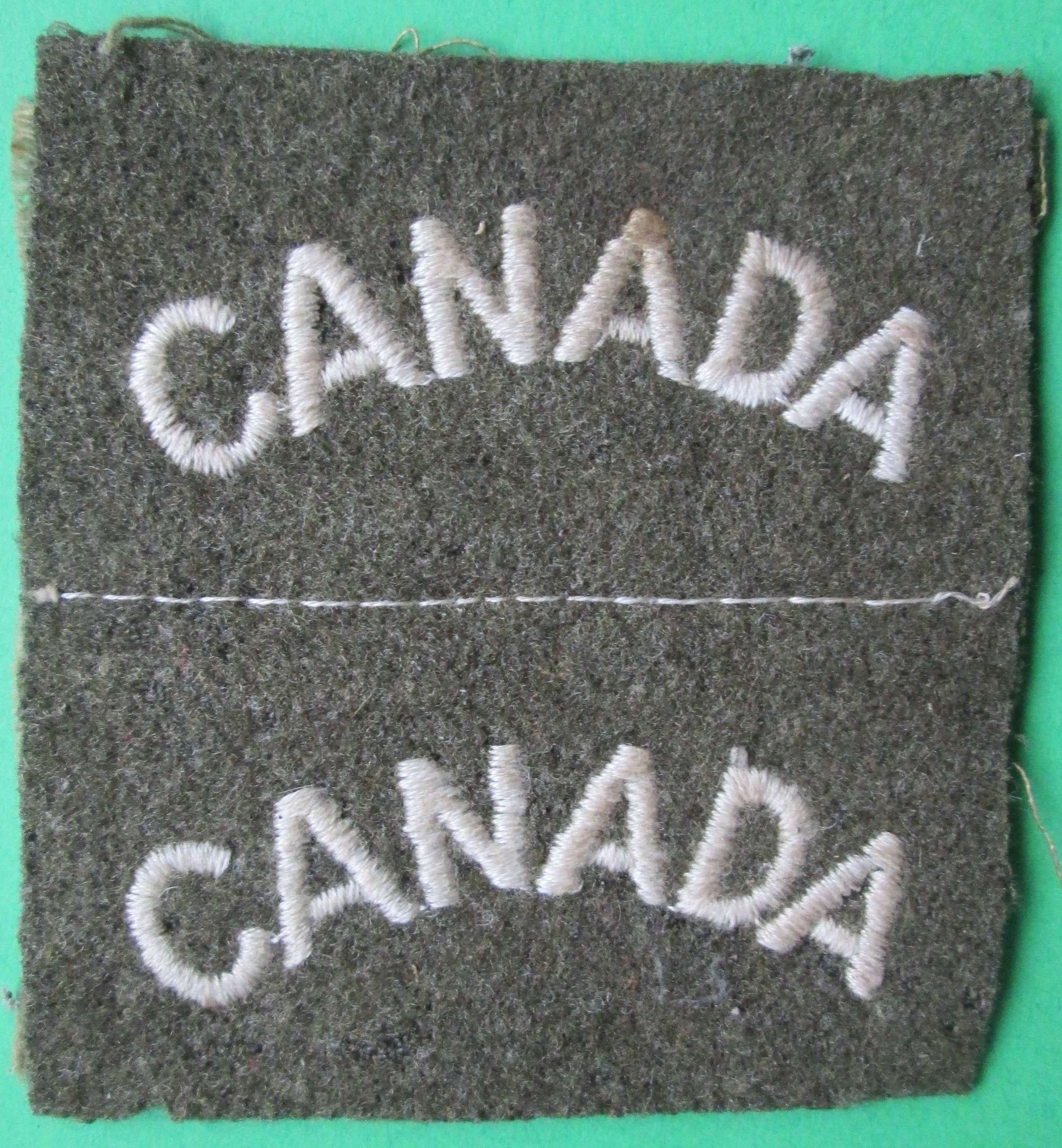 A GOOD UNCUT PAIR OF THE WWII CANADIAN SHOULDER TITLES