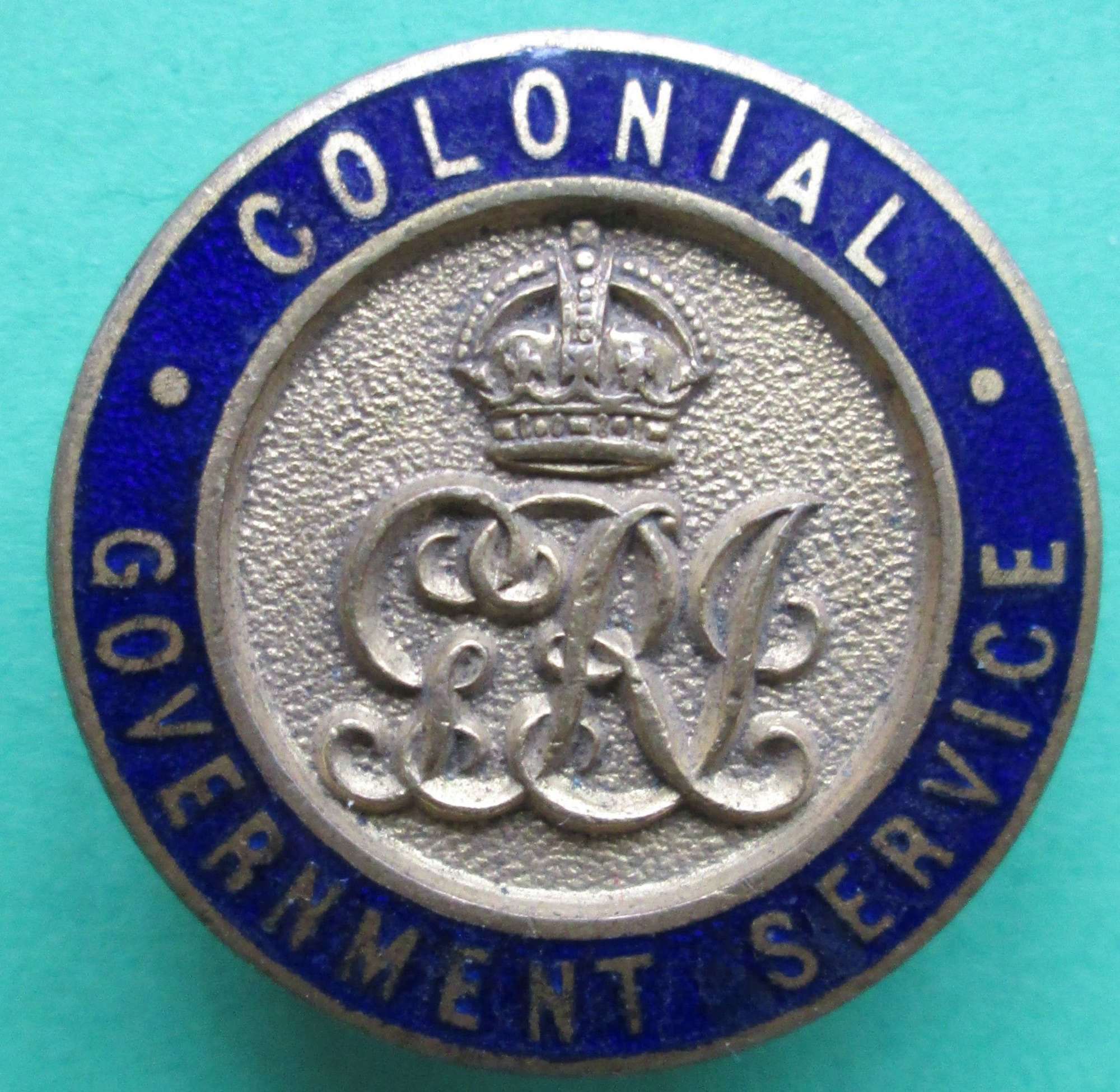 A COLONIAL GOVERNMENT SERVICE LAPEL BADGE