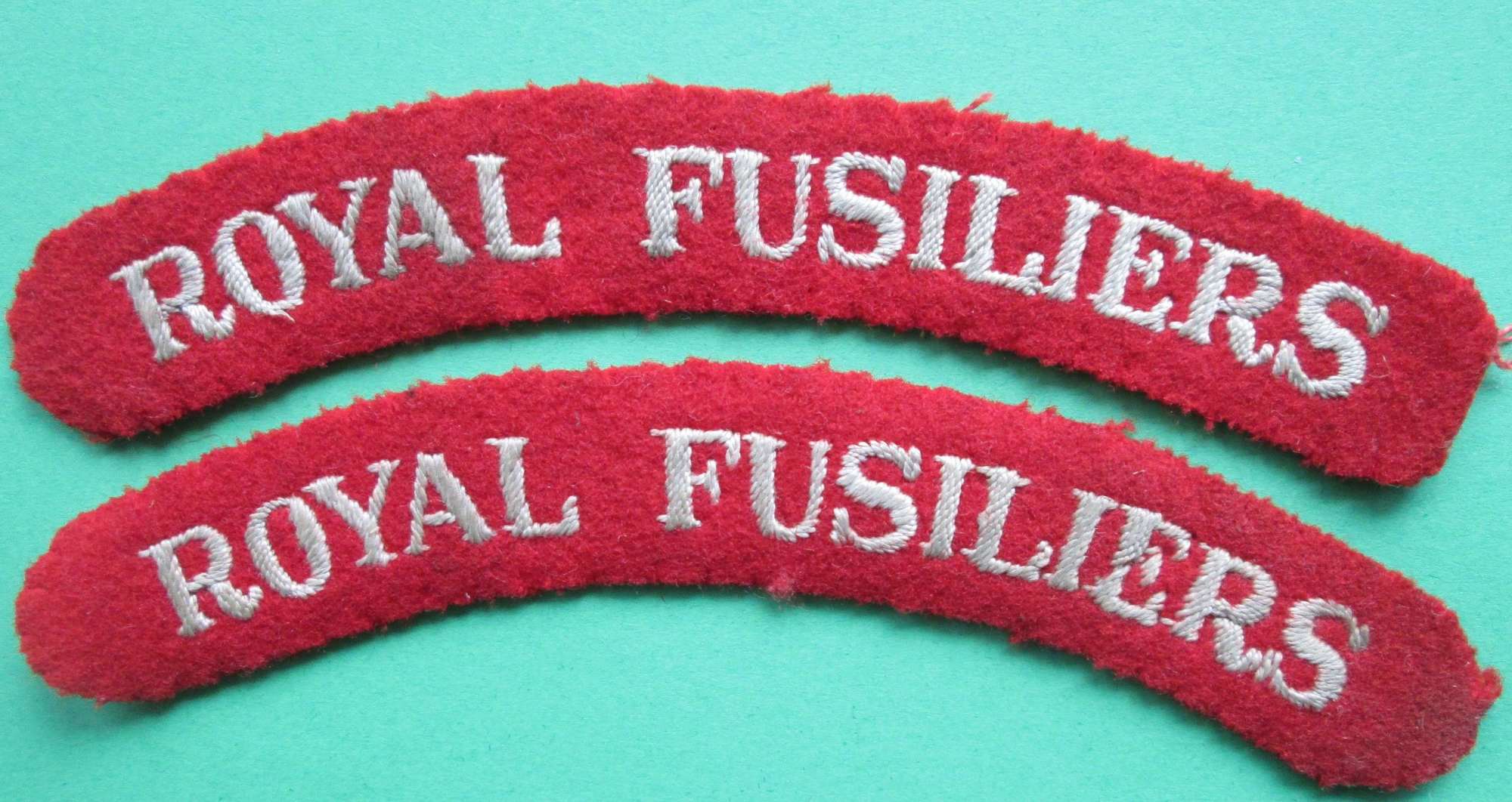 A PAIR OF ROYAL FUSILIERS SHOULDER TITLES