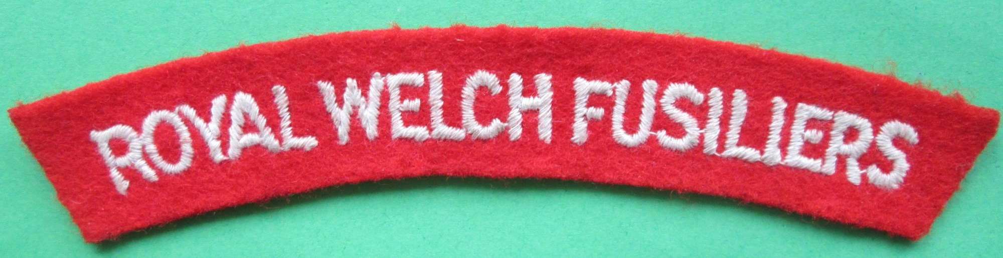 A WWII PASTE BACKED ROYAL WELCH FUSILIERS SHOULDER TITLE