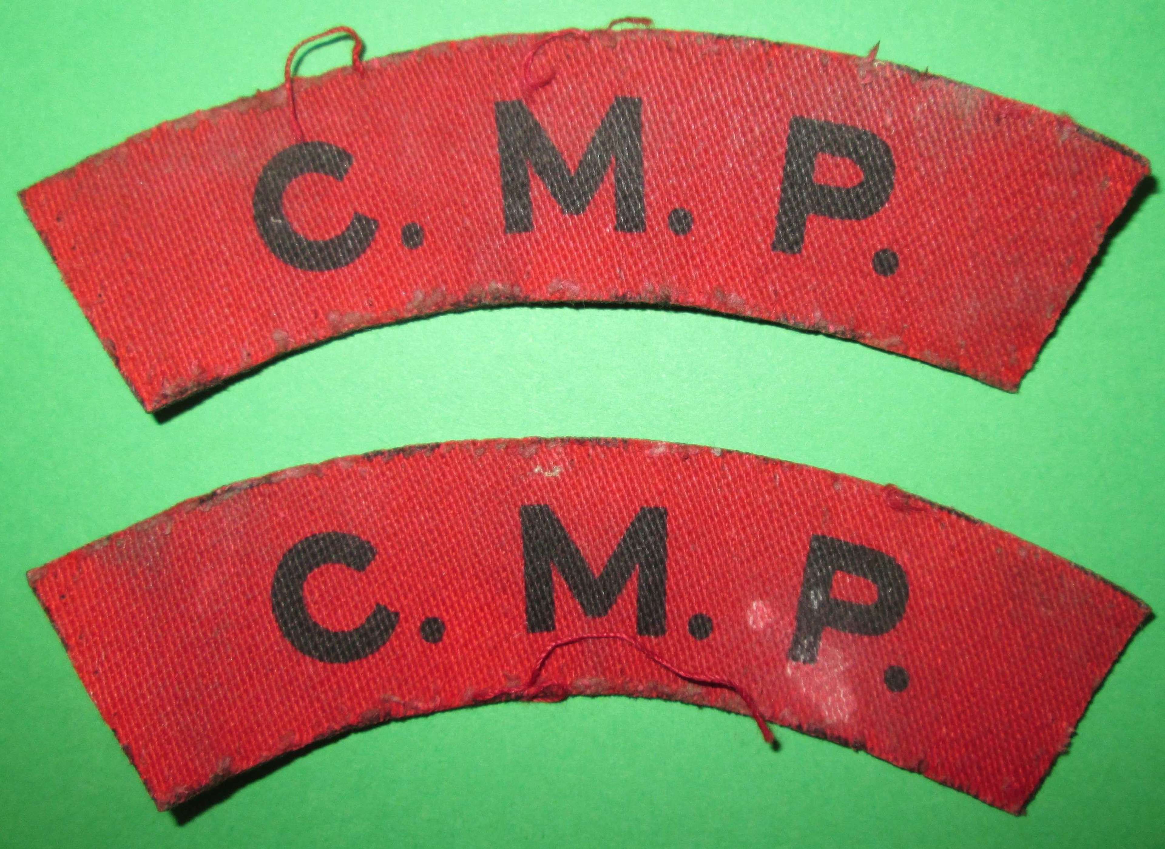 A PAIR OF PRINTED CORPS OF MILLITARY POLICE SHOULDER TITLES