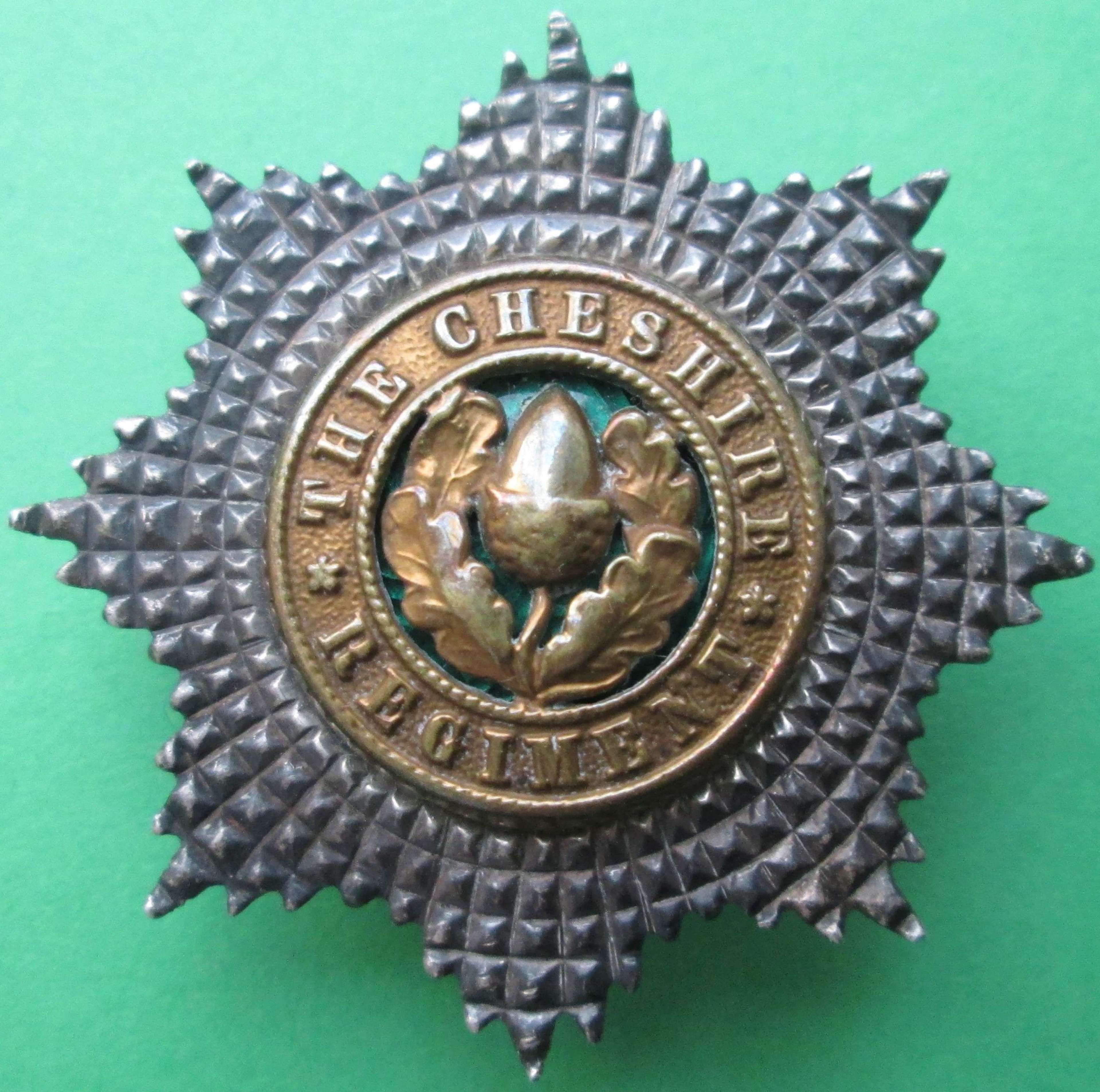 A GOOD WWII CHESHIRE REGT OFFICERS SILVER CAP BADGE