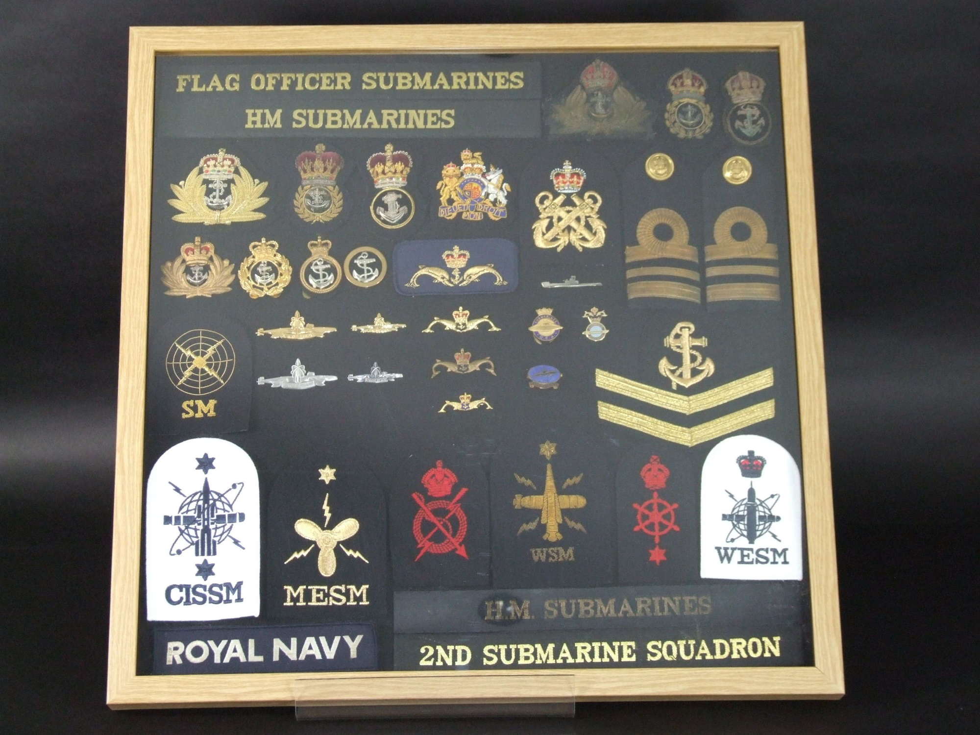 A Collection of Framed Royal Navy Badges