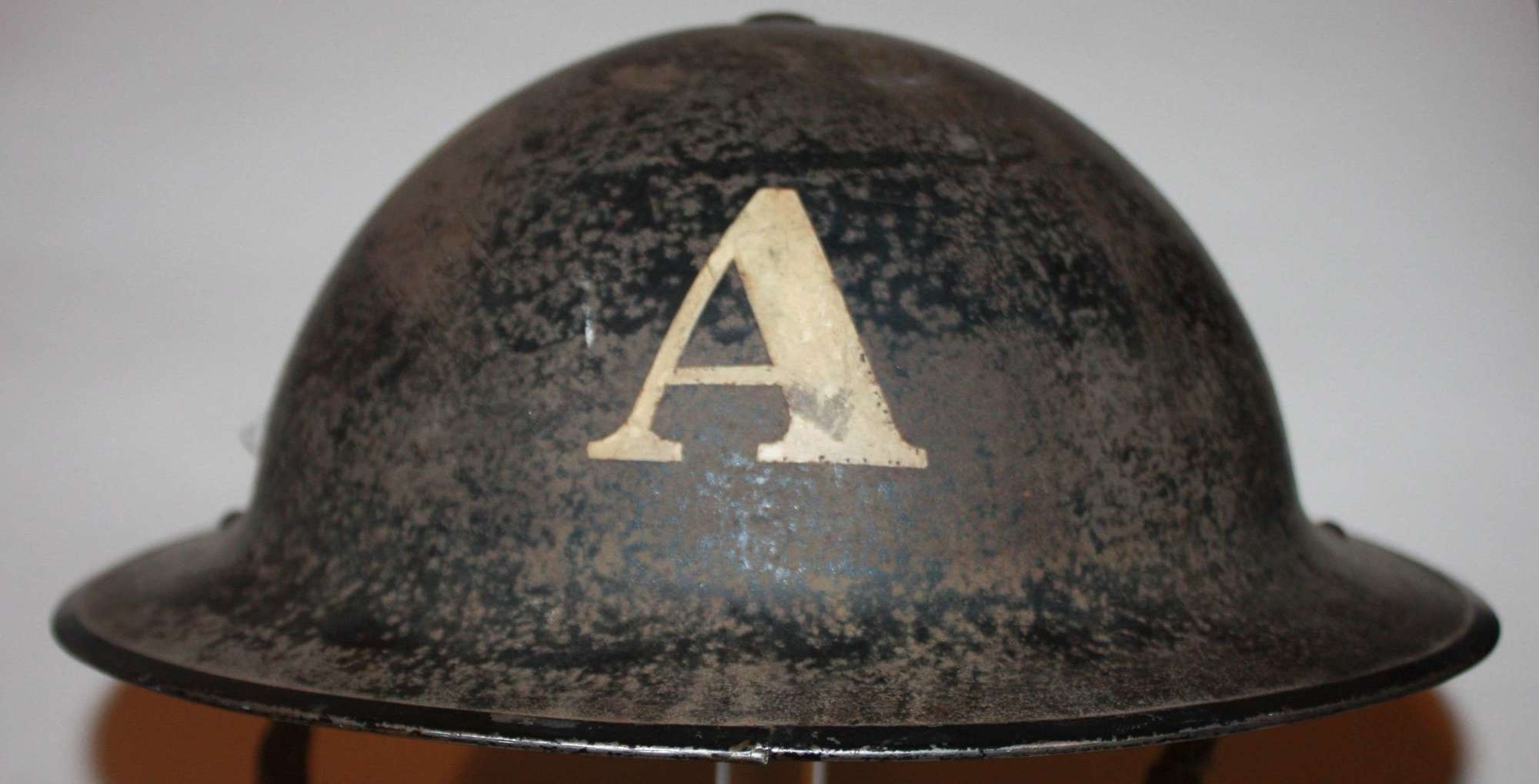 A WWII ambulance crew members black steel helmet