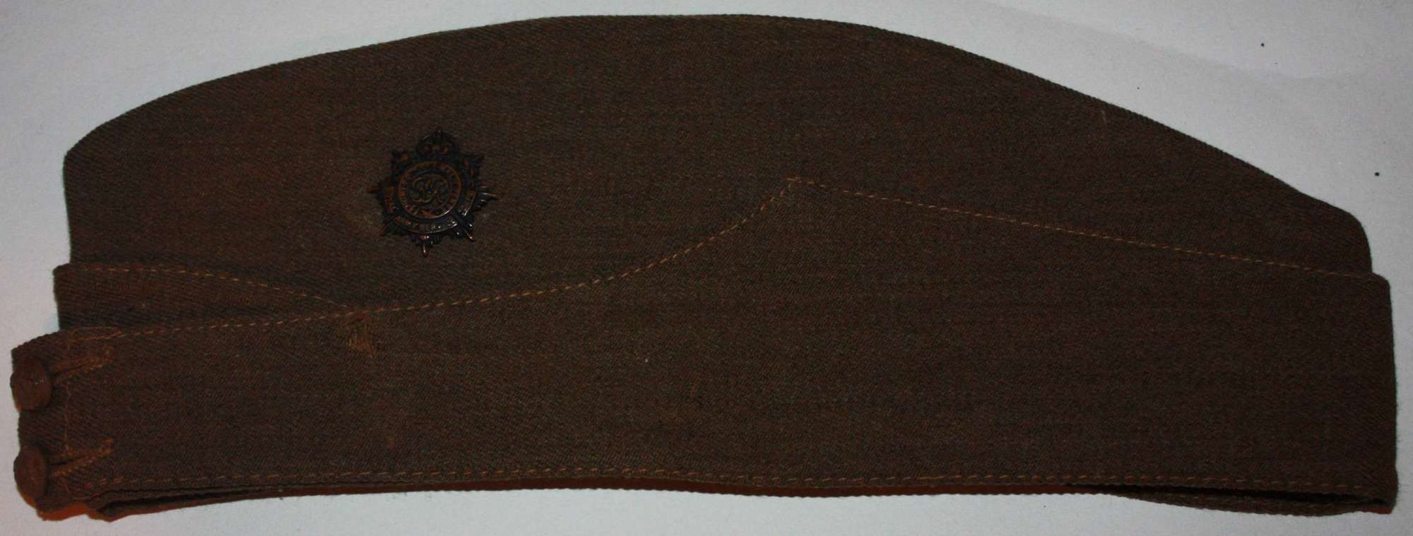 A GOOD 1942 DATED BRITISH  RASC SIDE CAP NAMED EXAMPLE