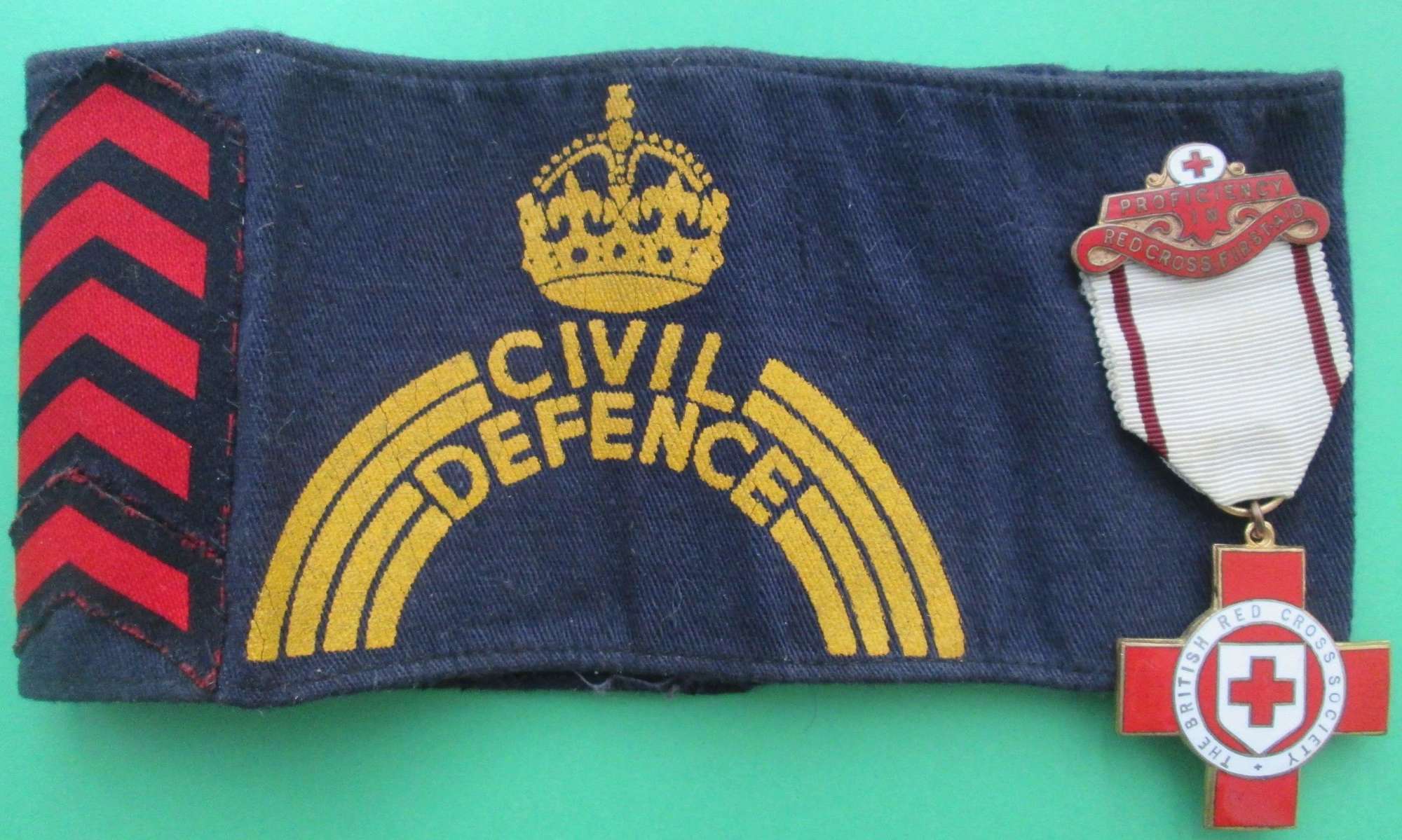 CIVIL DEFENCE ARM BAND WITH CHEVRONS AND FIRST AID MEDAL