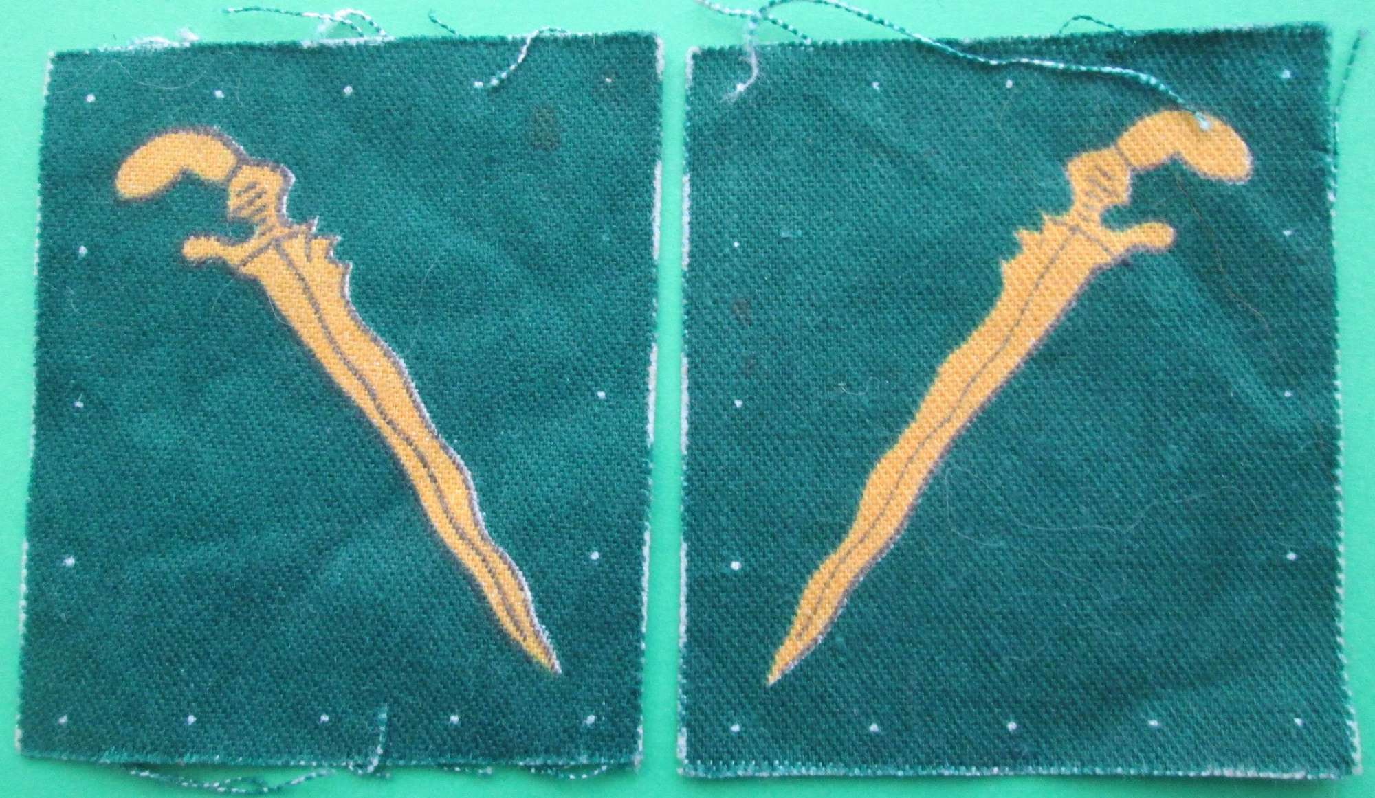 A PAIR OF UNCUT MALAYA COMMAND FORMATION SIGNS