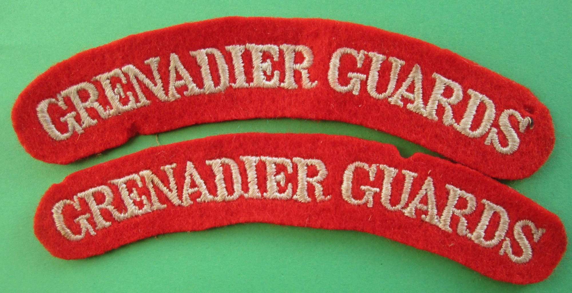 A PAIR OF GRENADIER GUARDS SHOULDER TITLES